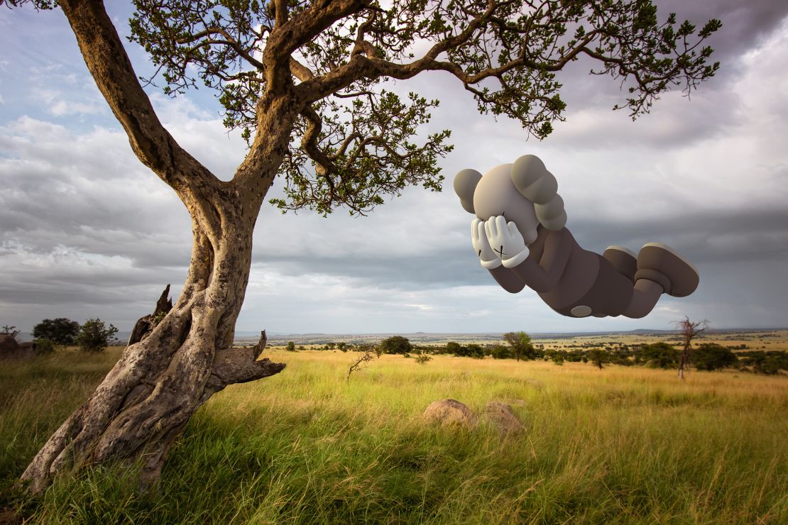 The AR KAWS Companion drifts over a field in Tanzania.