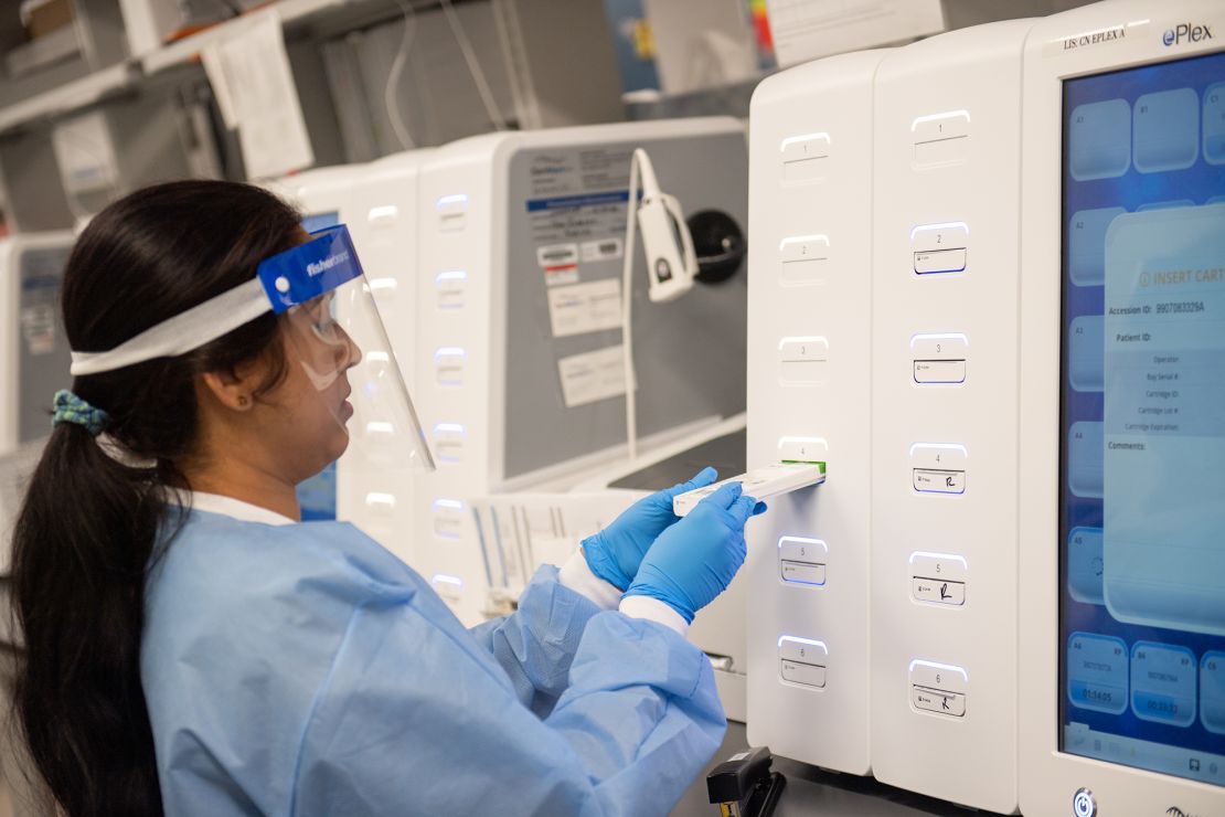  A lab technician begins semi-automated testing for COVID-19 on March 11 in Lake Success, New York. 