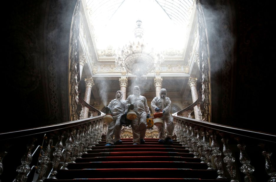 Workers in protective suits disinfect Istanbul's Dolmabahce Palace on March 11.