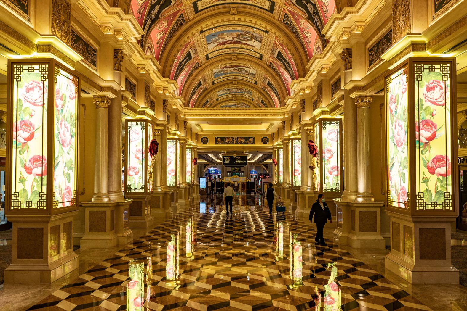 Staff members walk inside the Venetian Macau after it closed its casino on February 5.