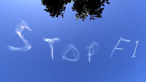 The words "Stop F1" are seen over the Sydney sky.