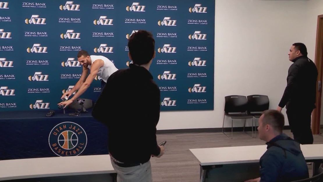 Before being tested postive for coronavirus, Gobert jokingly touches the microphones at a press conference.