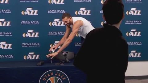Before being tested postive for coronavirus, Gobert jokingly touches the microphones at a press conference.