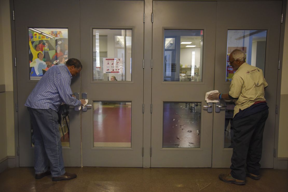 Volunteers at Central Union Mission men's homeless shelter disinfect surfaces in Washington DC.