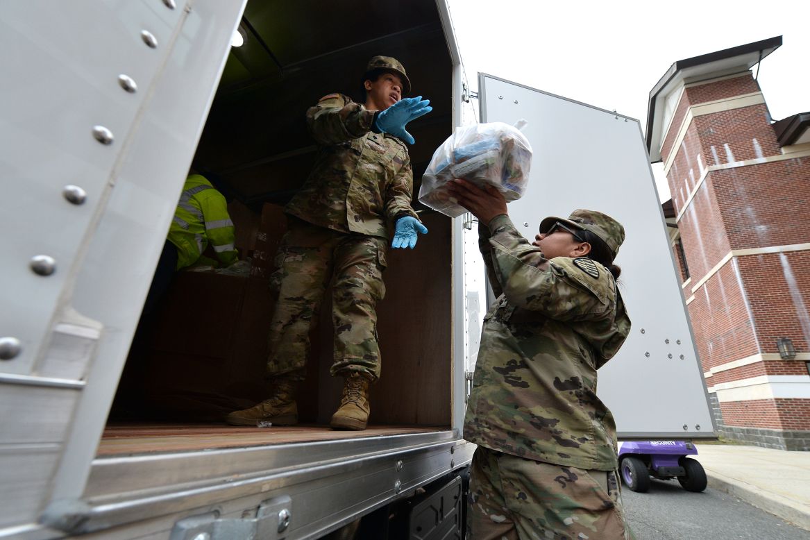 Members of the Army National Guard load bags of food for people in New Rochelle, New York, on Thursday, March 12. In an effort to slow the spread of the novel coronavirus, officials implemented <a href="https://www.cnn.com/2020/03/12/us/new-rochelle-coronavirus-containment-area/index.html" target="_blank">a 1-mile containment zone in New Rochelle,</a> a suburb outside New York City.