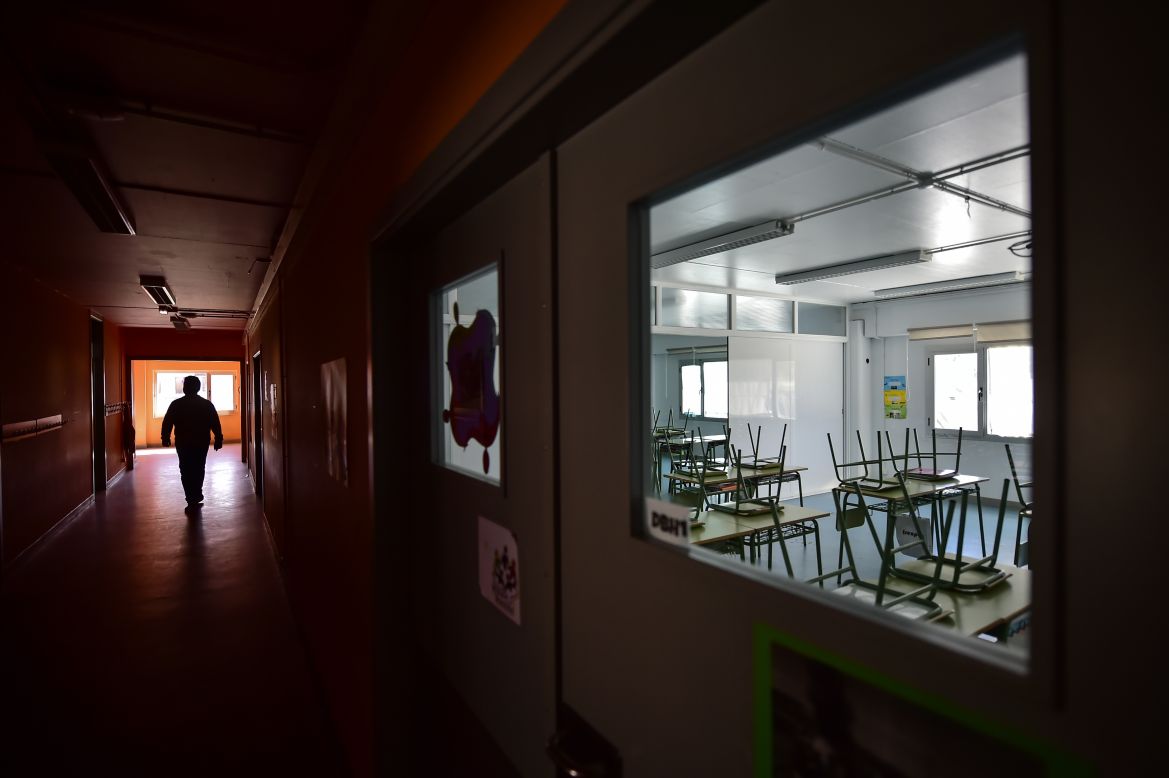 A teacher walks in an empty public school in Labastida, Spain, on March 11. The novel coronavirus is leaving <a href="http://www.cnn.com/2020/03/12/world/gallery/coronavirus-empty-spaces/index.html" target="_blank">empty spaces</a> across the globe as people are being told to stay home and avoid crowded areas.