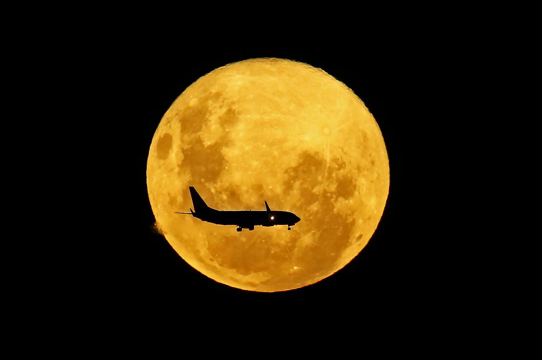 This image, taken in Brazil, shows a plane passing in front of the supermoon in March 2020.