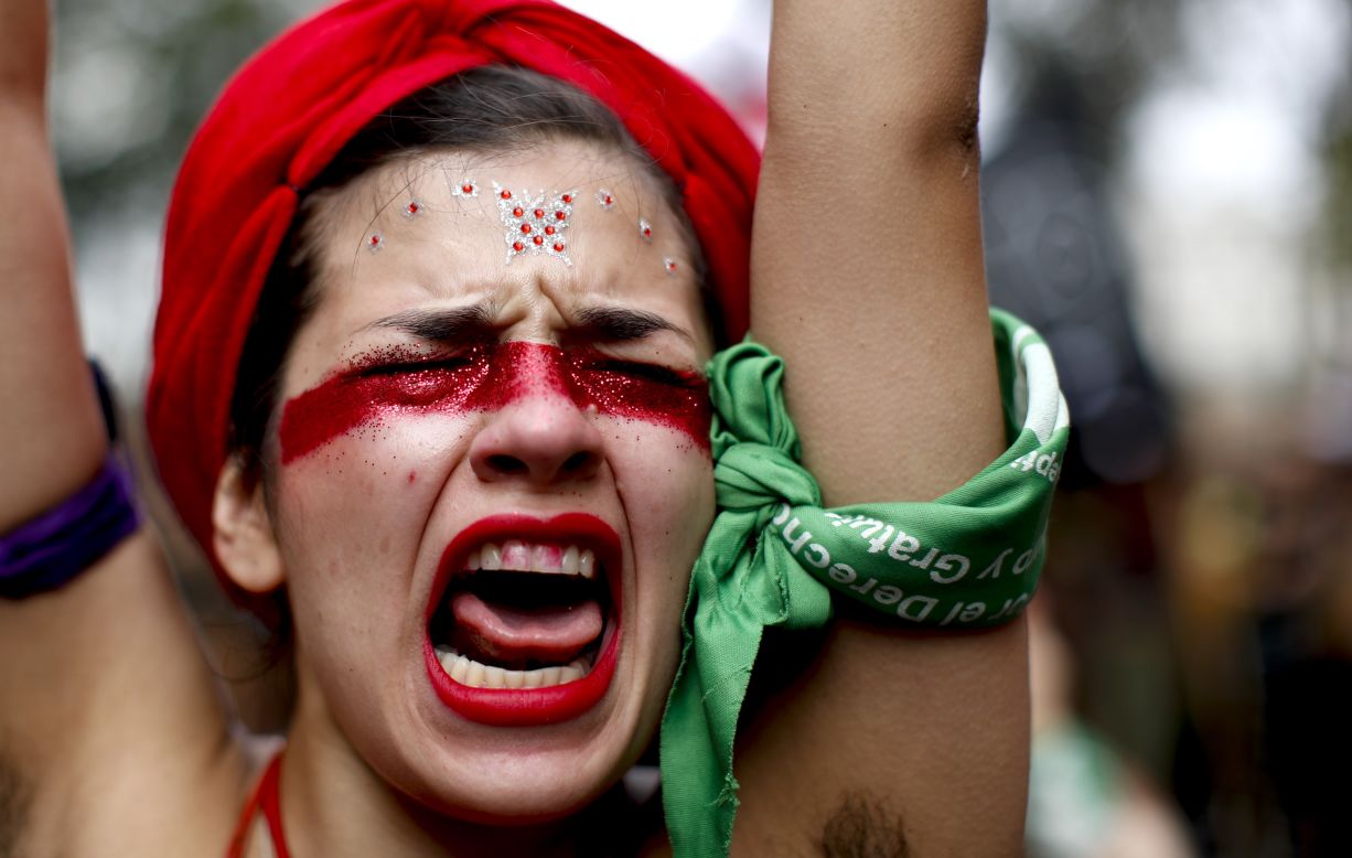 A woman in Buenos Aires shouts slogans as she marches to Congress to commemorate International Women's Day.