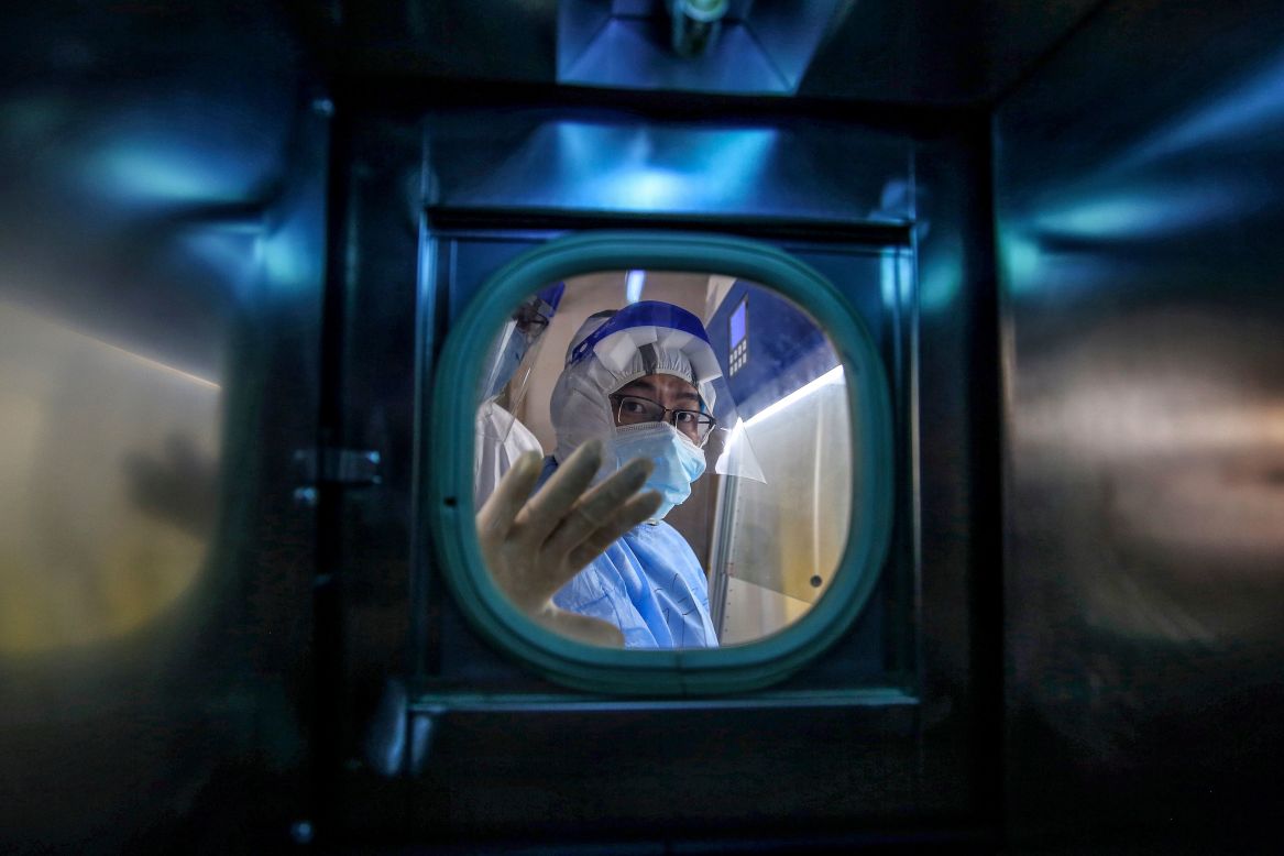 A medical staff member gestures inside an isolation ward at the Red Cross Hospital in Wuhan, China, on Tuesday, March 10. <a href="http://www.cnn.com/2020/01/23/world/gallery/wuhan-coronavirus-outbreak/index.html" target="_blank">The novel coronavirus</a> was first reported in Wuhan, a city of 11 million people in central China's Hubei province.
