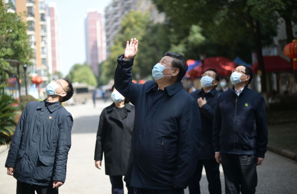 Chinese President Xi Jinping waves to people who are quarantined at their homes in Wuhan, China, on Tuesday, March 10.