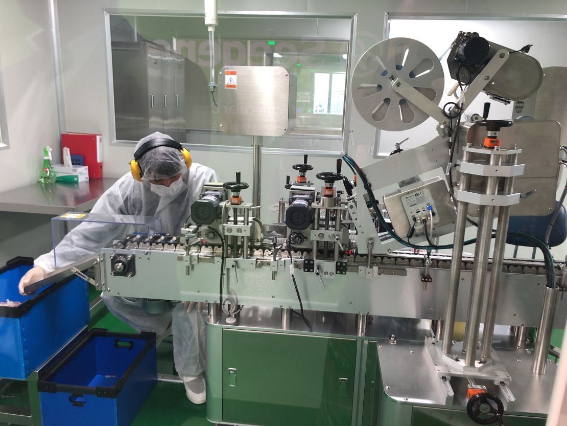 A worker at Seegene oversees an assembly line where test tubes are being labeled at Seegene's headquarters in Seoul, South Korea, on March 6, 2020.
