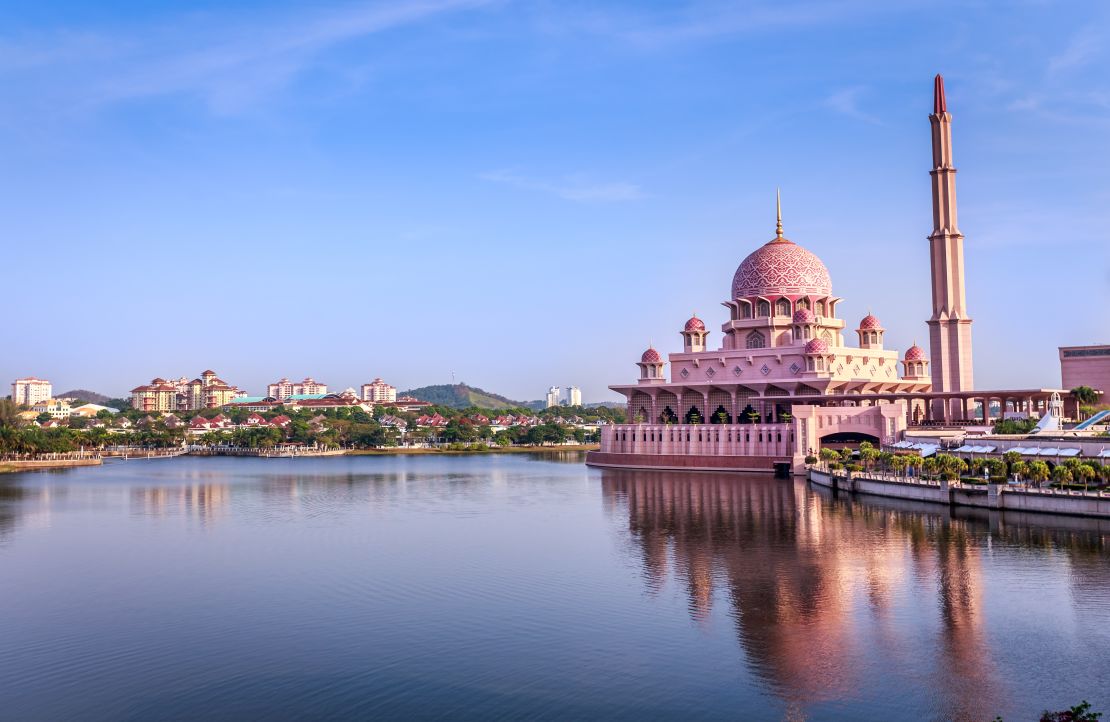 Putra Mosque in Putrajaya, Malaysia, is located at the edge of a manmade lake.