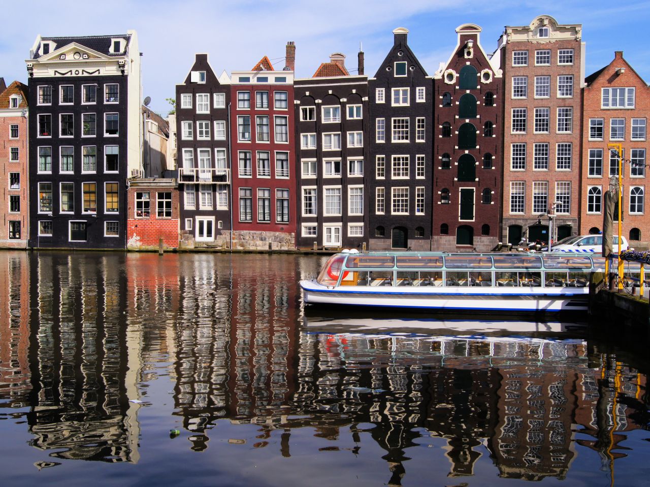 Traditional houses line canals in Amsterdam, the official capital of the Netherlands.