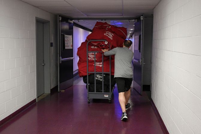 Paul Boyer, head equipment manager of the NHL's Detroit Red Wings, wheels out equipment bags in Washington on March 12, 2020. The NHL was among the sports leagues that had suspended their seasons.