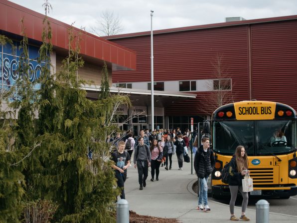 Students leave Glacier Peak High School in Snohomish, Washington, on March 12, 2020. Beginning the following day, schools in the Snohomish school district planned to be closed through April 24.