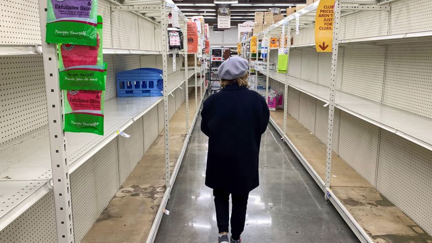 A shopper walks past empty shelves normally stocked with soaps, sanitizers, paper towels, and toilet paper at a Smart & Final grocery store, March 7, 2020 in Glendale, California. - Fears of coronavirus or COVID-19, the disease that has sickened more than 100,000 people worldwide and has killed more than 3,400, has led nervous residents to frantically stock up on canned food as well as cleaning and hygiene products. California prepared to disembark passengers from a virus-hit cruise ship as officials played down any risk to local communities. (Photo by Robyn Beck/AFP/Getty Images)
