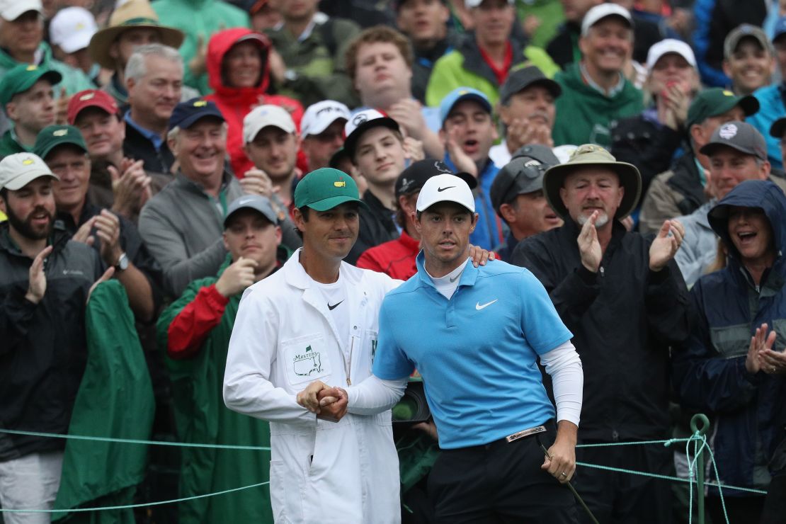 Rory McIlroy and caddie Harry Diamond shake hands on the 18th green during the third round of the 2018 Masters.