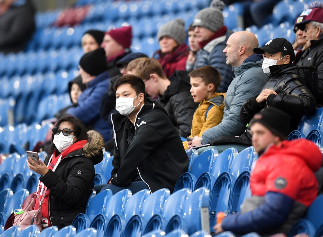 Fans wear disposable face masks  prior to the Premier League match between Burnley and Tottenham Hotspur.