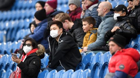 Fans wear disposable face masks prior to the Premier League match between Burnley and Tottenham Hotspur.