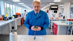 Britain's Prime Minister Boris Johnson gestures during a visit to the Mologic Laboratory in the Bedford technology Park, north of London on March 6, 2020. - The Prime Minister pledged a further £46 million for research into a coronavirus vaccine and rapid diagnostic tests during the visit to the Laboratory, where British scientists are working on ways to diagnose coronavirus. (Photo by Jack Hill / POOL / AFP) (Photo by JACK HILL/POOL/AFP via Getty Images)
