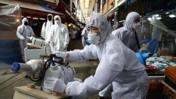 SEOUL, SOUTH KOREA - FEBRUARY 26: Disinfection professionals wearing protective gear spray anti-septic solution against the coronavirus (COVID-19) at a traditional market on February 26, 2020 in Seoul, South Korea. Government has raised the coronavirus alert to the "highest level" as confirmed case numbers keep rising. Government reported 169 new cases of the coronavirus (COVID-19) bringing the total number of infections in the nation to 1,146 with the potentially fatal illness spreading fast across the country. (Photo by Chung Sung-Jun/Getty Images)