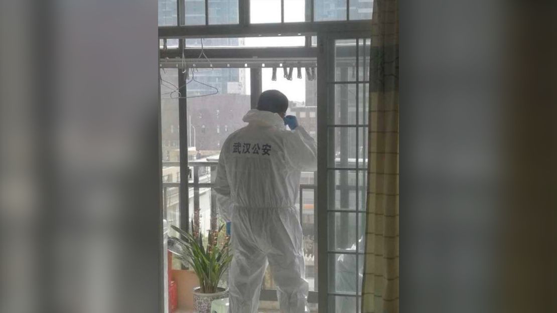A photo on Wechat shows a local policeman in protective suit stationed on a balcony to discourage any potential yelling or jeers from residents.