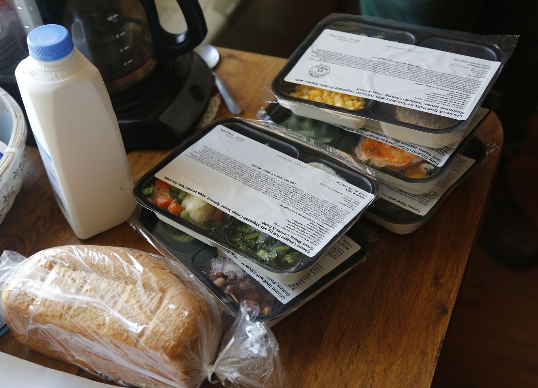 Volunteers at Meals on Wheels deliver food to a man in Portland.