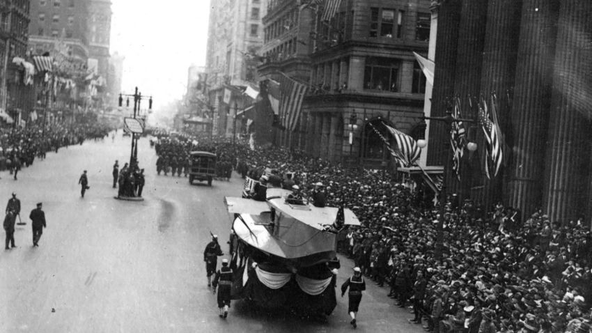 Liberty Loan Parade at Philadelphia, Pennsylvania, 28 September 1918. Naval Aircraft Factory float, featuring the hull of a F5L patrol seaplane, going south on Broad Street, escorted by Sailors with rifles. This parade, with its associated dense gatherings of people, contributed significantly to the massive outbreak of influenza which struck Philadelphia a few days later.