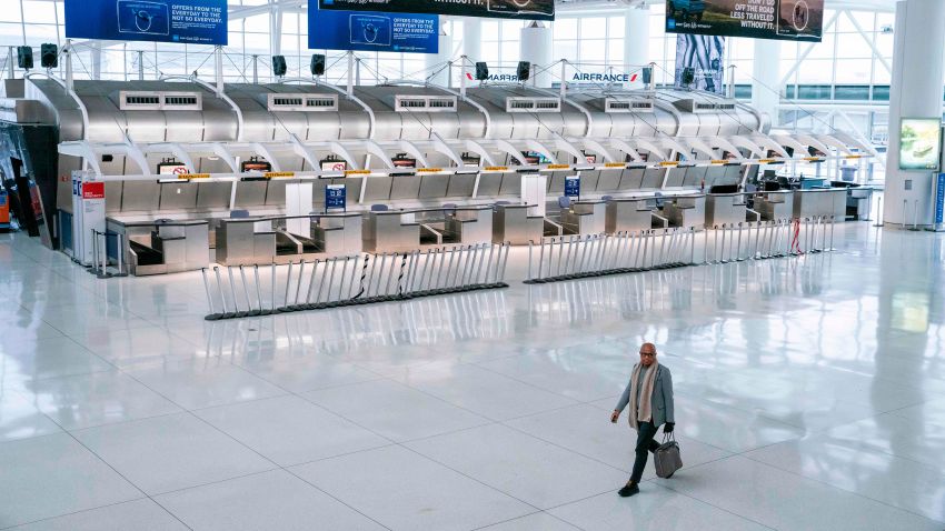 A man walks past the closed Air France counters at the Terminal 1 section at John F. Kennedy International Airport on March 12, 2020 in New York City. - US President Donald Trump announced a shock 30-day ban on travel from mainland Europe over the coronavirus pandemic that has sparked unprecedented lockdowns, widespread panic and another financial market meltdown Thursday.The announcement came as China, where the outbreak that first emerged in December, showed a dramatic drop in new cases and claimed "the peak" of the epidemic had passed. (Photo by Kena Betancur / AFP) (Photo by KENA BETANCUR/AFP via Getty Images)