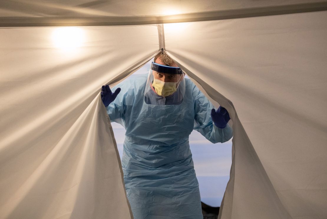 A nurse wearing protective clothing emerges from a tent at a coronavirus testing center at the University of Washington Medical Center on March 13 in Seattle.