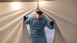 SEATTLE, WASHINGTON - MARCH 13: A nurse wearing protective clothing emerges from a tent a a coronavirus testing center at the University of Washington Medical center on March 13, 2020 in Seattle, Washington. UW Medical staff feeling potential symptoms of COVID-19 were asked to pass through a drive-through screening center on campus for testing.  (Photo by John Moore/Getty Images)