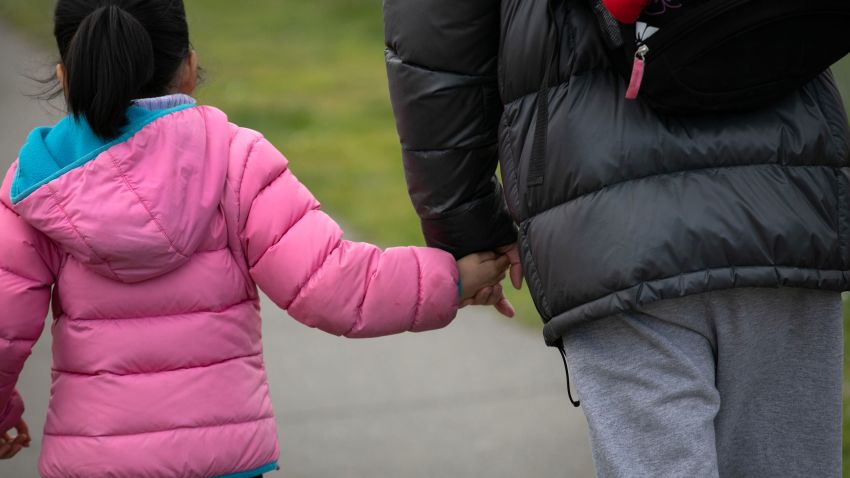 SEATTLE, WASHINGTON - MARCH 11: A student leaves the Thurgood Marshal Elementary school with a parent after the Seattle Public School system was abruptly closed due to coronavirus fears on March 11, 2020 in Seattle, Washington. Schools will be closed for a minimum of two weeks. The system is the largest public school district in Washington State. (Photo by John Moore/Getty Images)