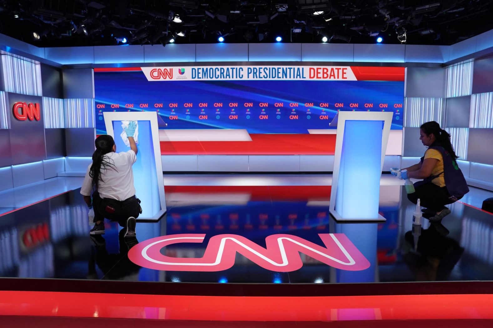 Workers wipe down the podiums before the debate.