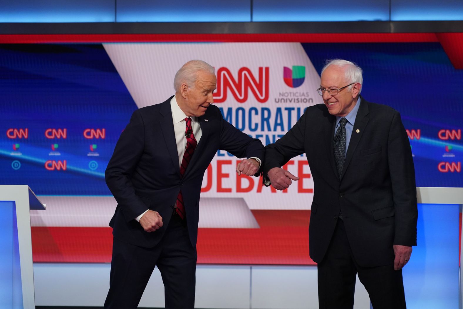 Biden greets Sanders with an elbow bump before the start of a debate in Washington in March 2020. They went with an elbow bump instead of a handshake because of the coronavirus pandemic.