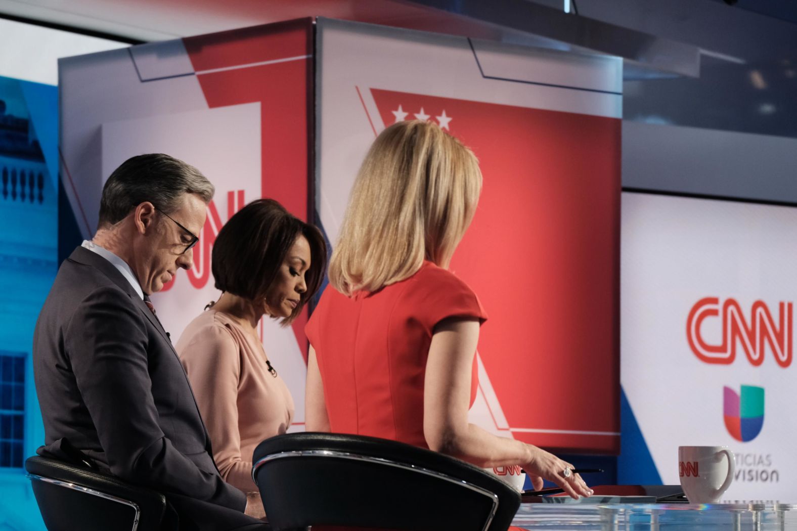 The moderators look over notes during a commercial break. From left are CNN's Jake Tapper, Univision's Ilia Calderón and CNN's Dana Bash.