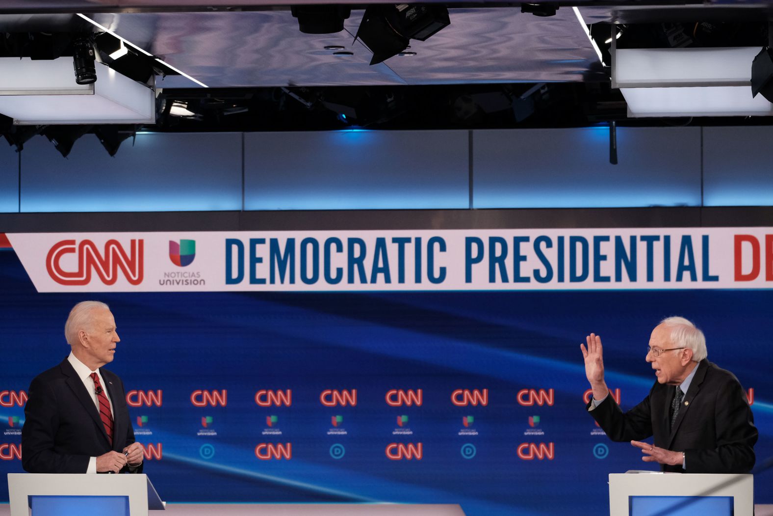 The podiums are 6 feet apart, per recommendations from the Centers for Disease Control and Prevention.