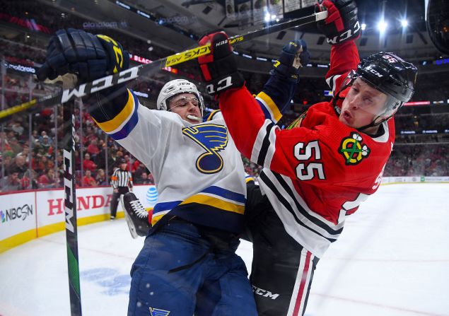 St. Louis' Sammy Blais, left, checks Chicago's Nick Seeler during an NHL game in Chicago on Sunday, March 8. The NHL suspended its season later in the week, as did many other sports leagues, because of the coronavirus pandemic.