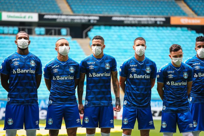 Gremio soccer players wear masks in protest before playing Sao Luiz in Porte Alegre, Brazil, on Sunday, March 15. The match was played behind closed doors.
