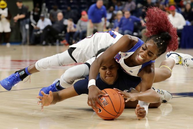 DePaul forward Chante Stonewall lands on Marquette guard Camryn Taylor as they go for a loose ball during the Big East Tournament on Monday, March 9.