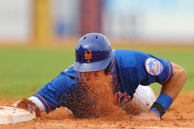 Ryan Cordell of the New York Mets slides into first base during a spring-training game in Port St. Lucie, Florida, on Sunday, March 8.