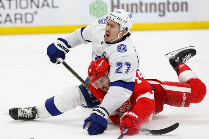 Tampa Bay's Ryan McDonagh falls on Detroit's Robby Fabbri during an NHL game in Detroit on Sunday, March 8.