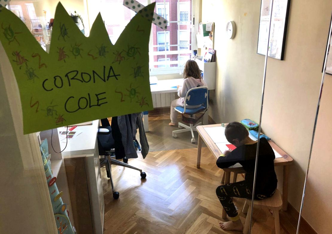 Adriana, 7, and Marcos, 5, do their schoolwork at home in Madrid, Spain. 