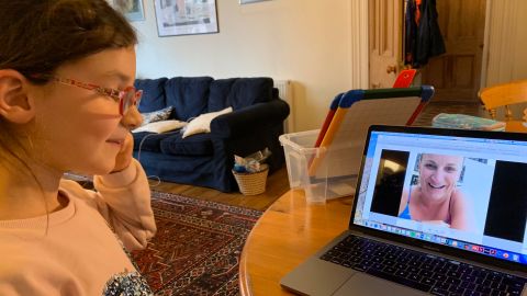 Rosalyn works on a lesson with a teacher online from home.