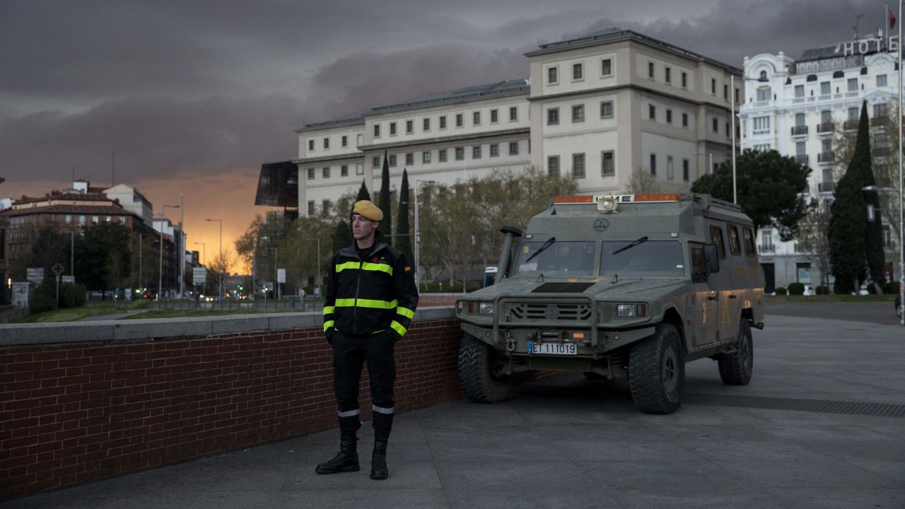 A member of the Spanish Military Emergency Unit (UME) stands guard near Madrid's Atocha train station on Sunday.