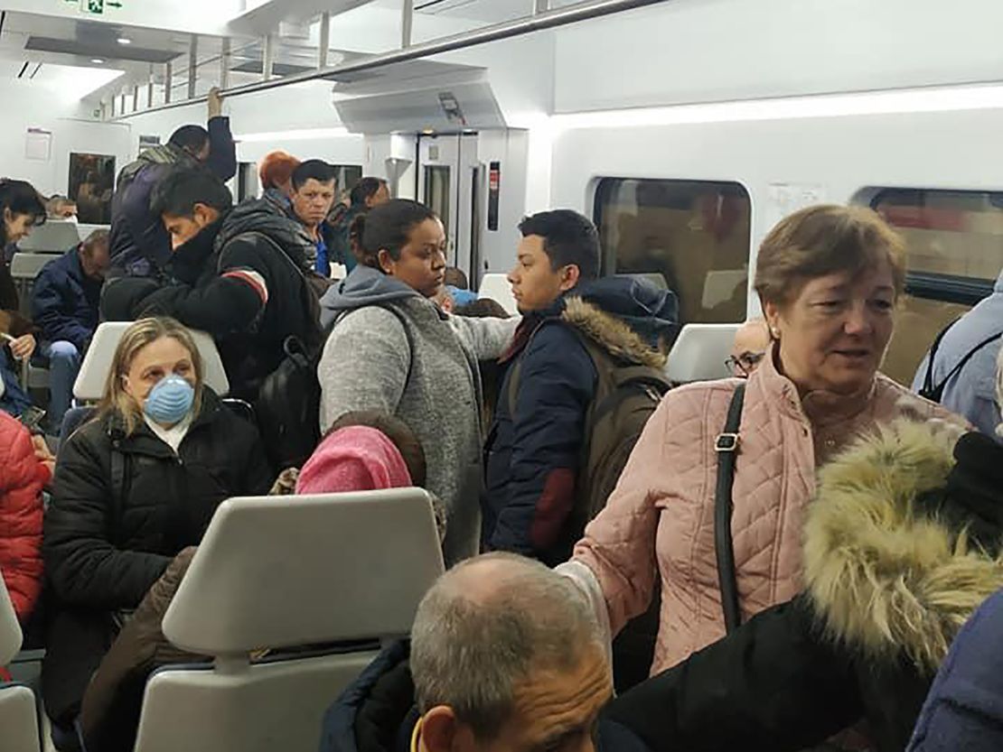 Commuters on a busy train at Madrid's Atocha train station.