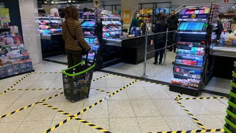 At a supermarket in central Madrid, lines taped on the ground indicate how far apart customers should stand.