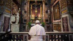 TOPSHOT - This handout picture released by the Vatican Media shows Pope Francis, in Rome on March 15, 2020, prays in S. Marcello al Corso church, where there is a miraculous crucifix that in 1552 was carried in a procession around Rome to stop the great plague. - The Vatican said on March 15, that its traditional Easter week celebrations would be held this year without worshippers due to the coronavirus. "Because of the current global public health emergency, all the liturgical celebrations of Holy Week will take place without the physical presence of the faithful," the Prefecture of the Pontifical Household said in a statement. (Photo by - / VATICAN MEDIA / AFP) (Photo by -/VATICAN MEDIA/AFP via Getty Images)