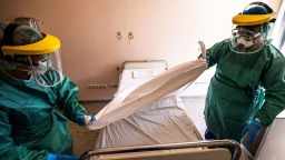 Nurses in protective gear prepare a ward designated for receiving new patents infected with the Covid-19 virus in a hospital in Budapest, Hungary, 16 March 2020.