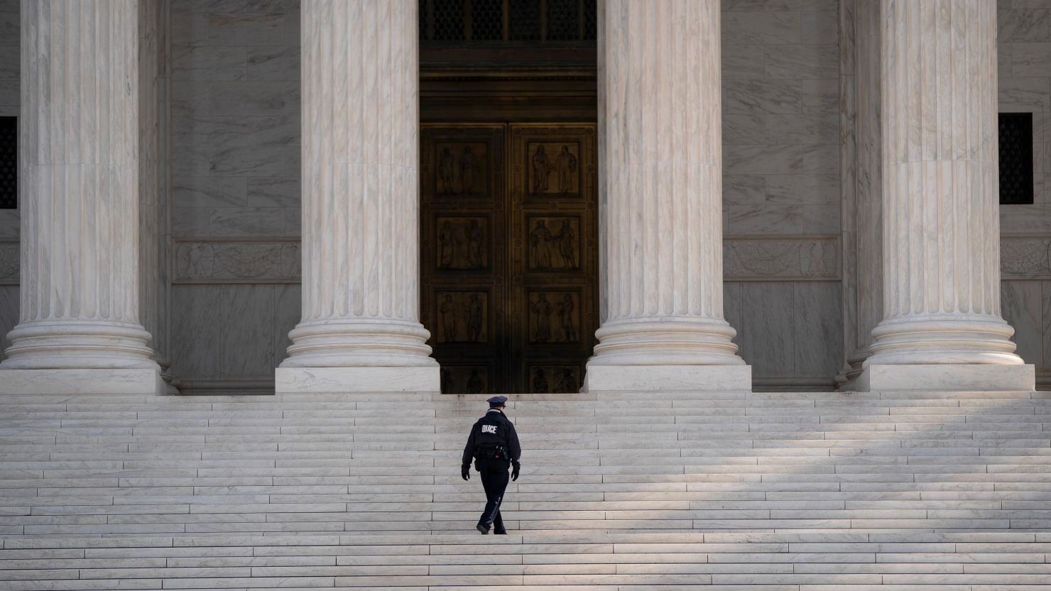 A Supreme Court police officer walks up the steps at the US Supreme Court on Monday, March 16, in Washington.