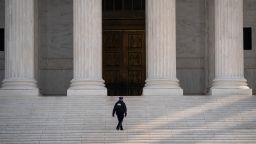 A Supreme Court Police officer walks up the steps at the U.S. Supreme Court on March 16, 2020 in Washington, DC. The Supreme Court announced on Monday that it would postpone oral arguments for its March session because of the coronavirus outbreak. 